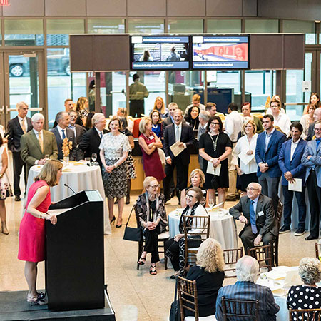 Speaker addressing a group of smiling people