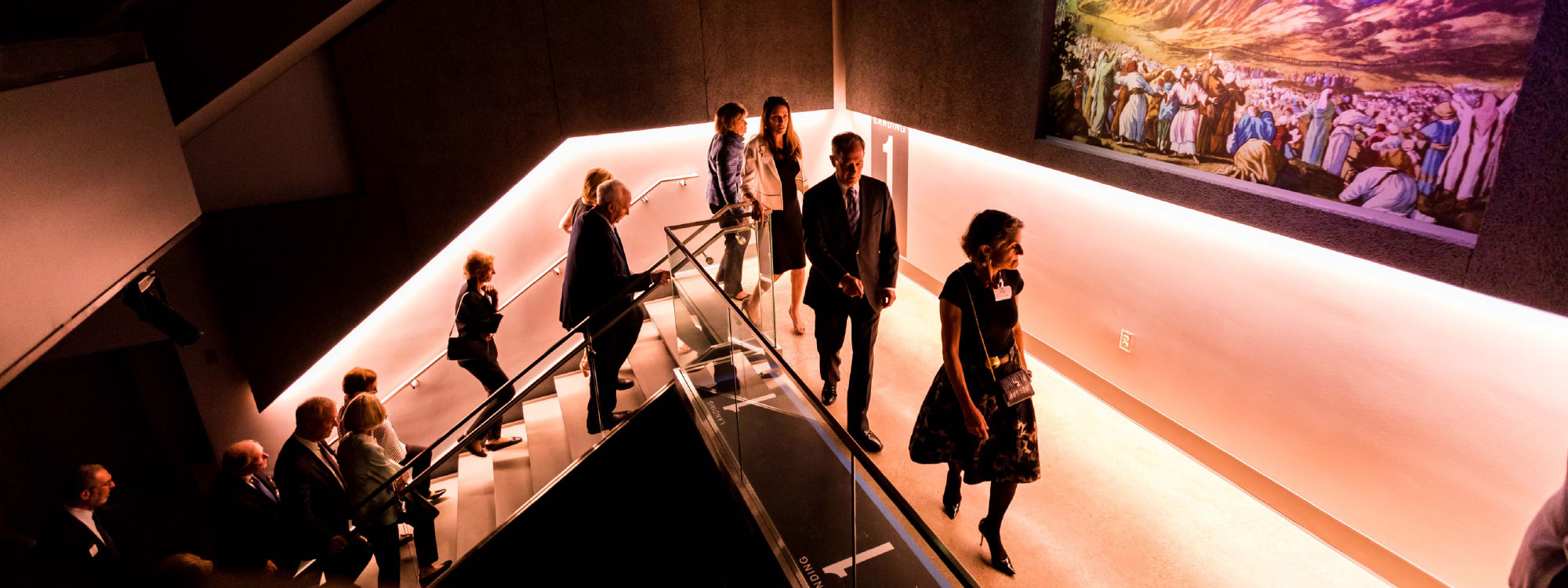 people walking up the Exhibition Wing staircase