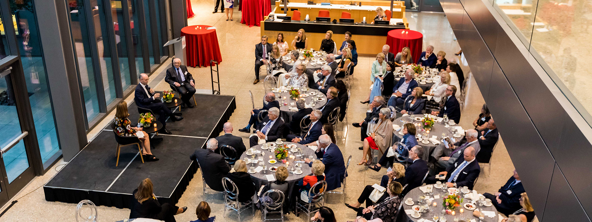 Guests sitting at a tables listening to a speaker